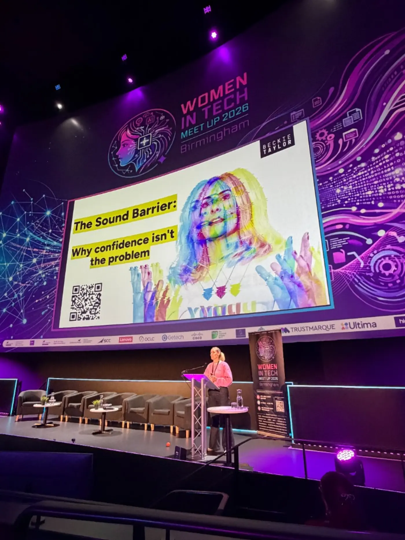 Beckie Taylor speaking on stage at Women in Tech Meet Up 2026 — The Sound Barrier