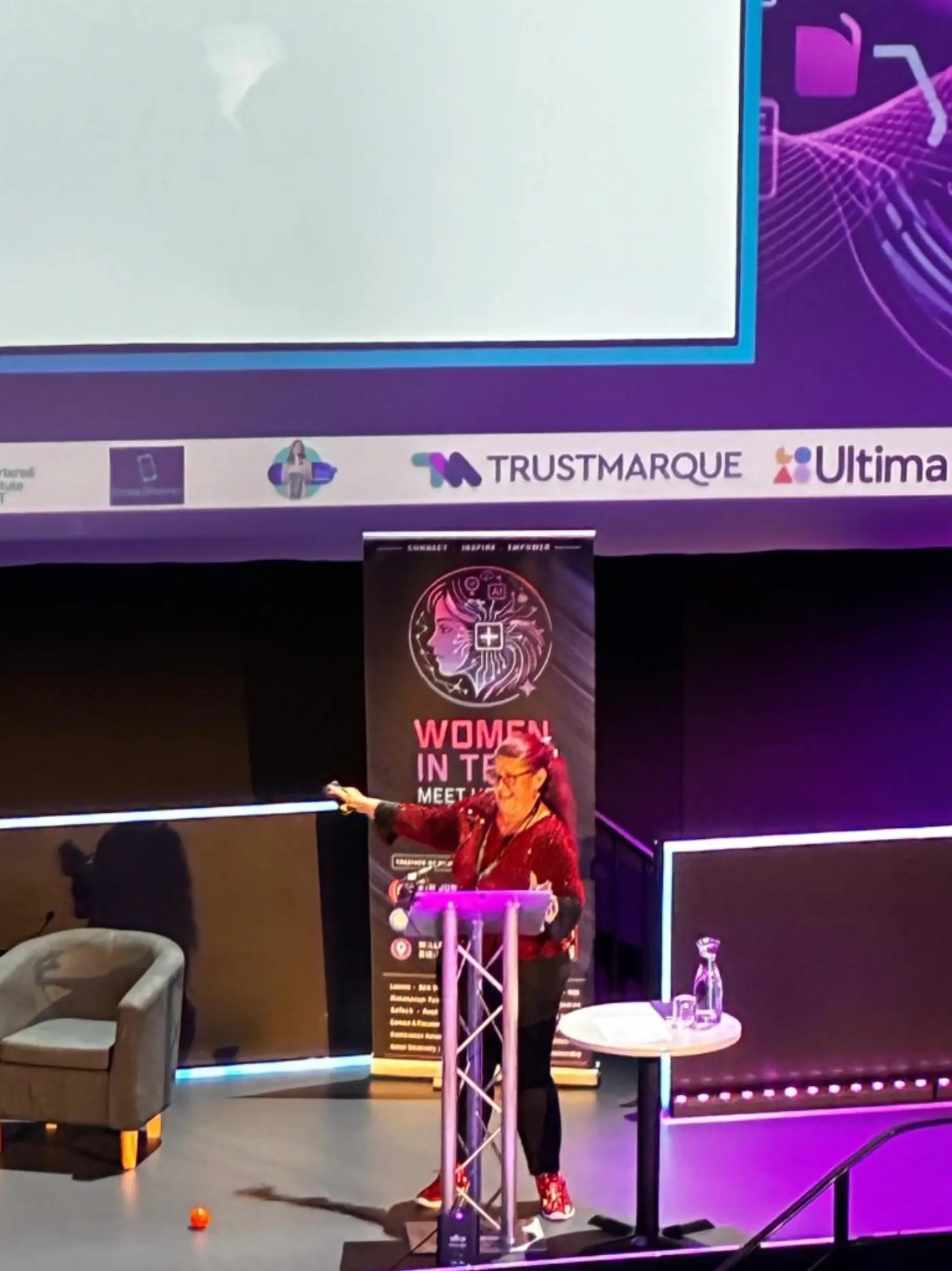 Heather Perriam speaking on stage at Women in Tech Meet Up 2026