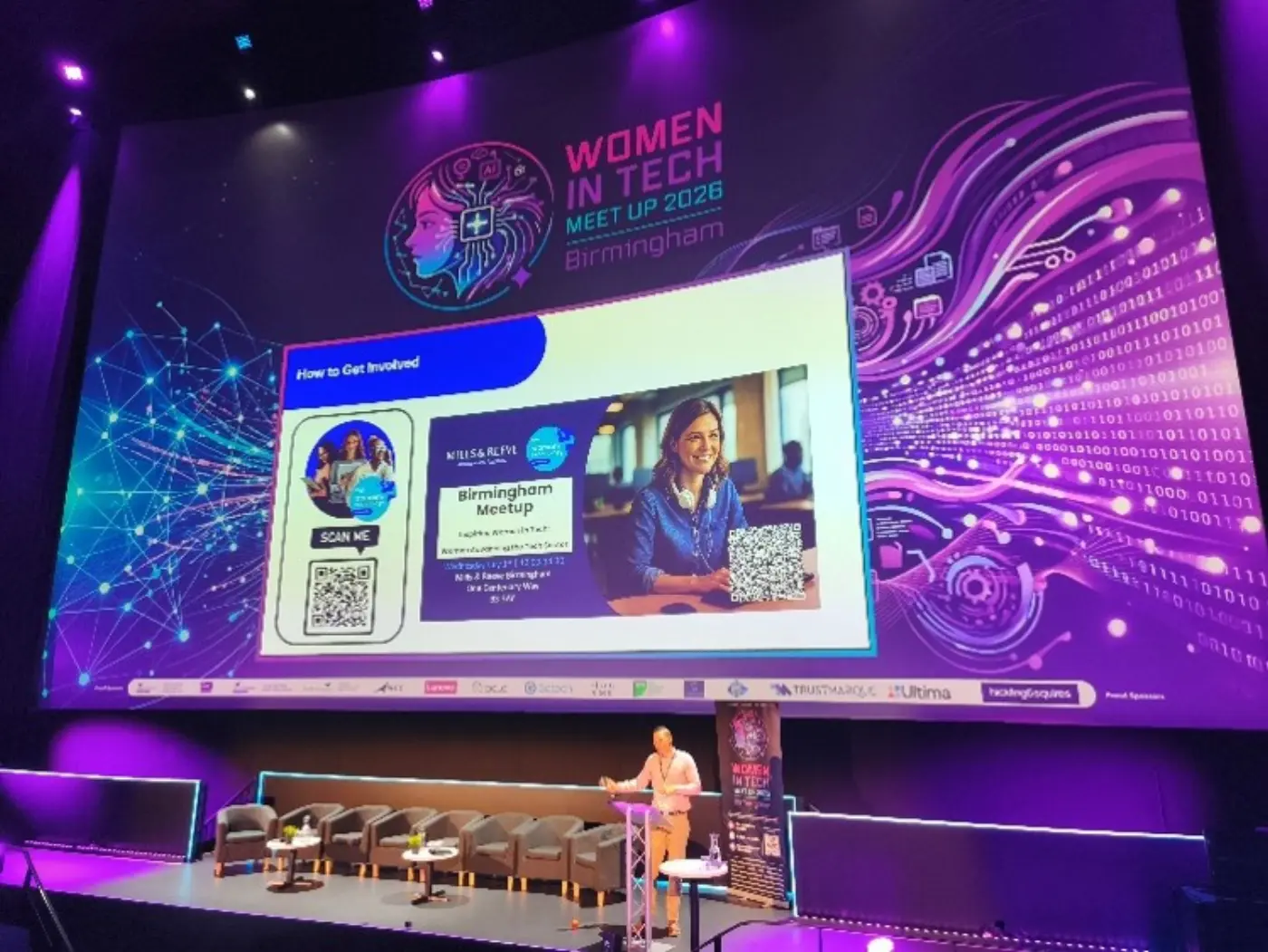 Stage at Women in Tech Meet Up 2026 Birmingham with speaker and panel seating